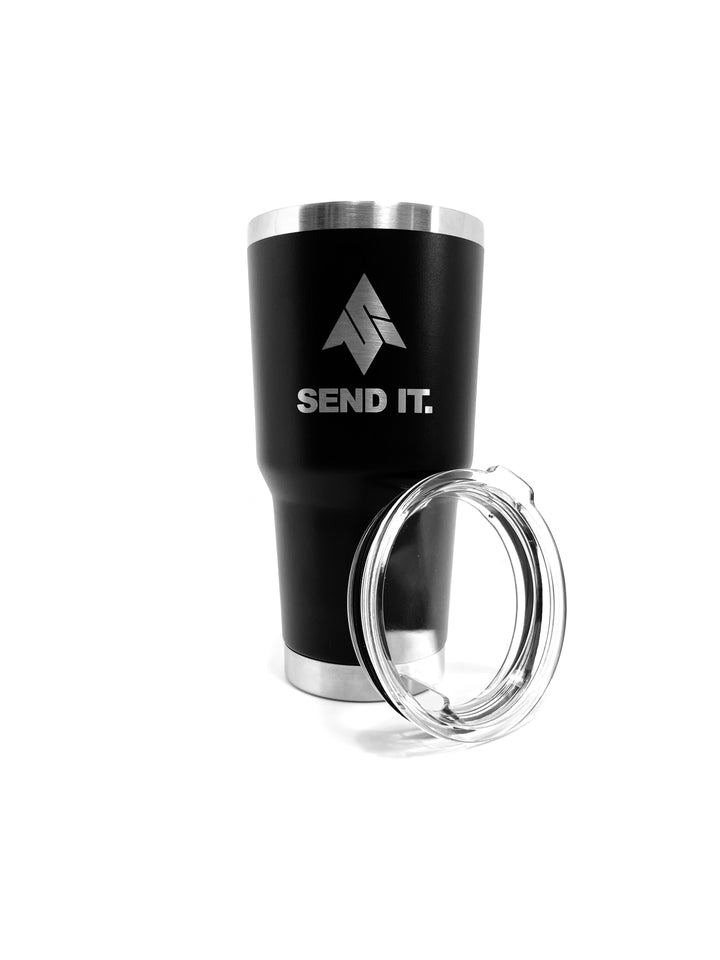 The send it 30oz tumbler with lid shown in front of the send it 30 oz stainless steel vacuum insulated tumbler. The send it tumbler features the iconic send it logo laser etched onto the tumbler.